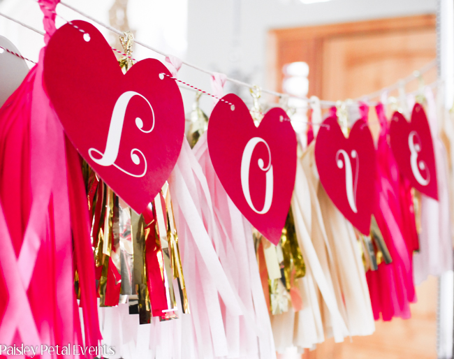 Red hearts printable banner for Valentine's Day decor. Add tissue tassels underneath for more depth to your banner.